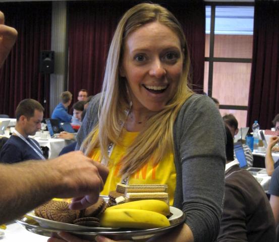 svettes holding a tray of fruit and cookies